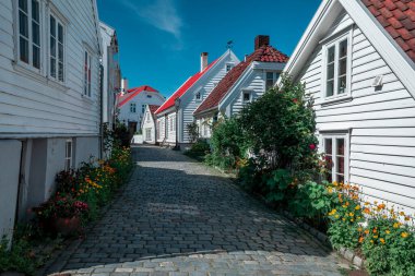 Old town Gamle Stavanger with white timber houses in Norway, during sunshine and blue sky