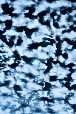 Melting ice in a lake of Hardangervidda in Norway from above