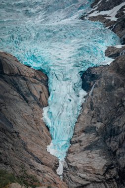 Briksdalsbreen glacier in the mountains of Jostedalsbreen national park in Norway, blue ice melting in summer