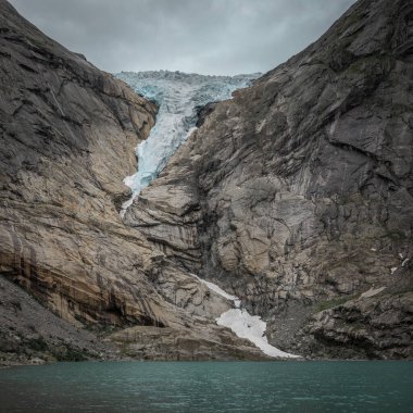 Briksdalsbreen glacier ice in the mountains of Jostedalsbreen national park in Norway, turquoise glacier lake
