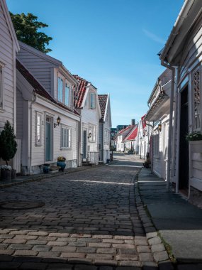 Old town Gamle Stavanger with white timber houses in Norway, during sunshine and blue sky