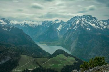 Timlapse of moving clouds above lake Knigssee at Berchtesgaden Bavaria, mountain scenery in the background with snow-capped mountains