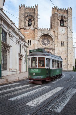 Lizbon 'un başkentinde turist tramvayı. Eski Alfama, Portekiz' deki kilisenin önünde.