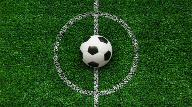 Saha merkezindeki bir futbol topunun en üst görüntüsü.