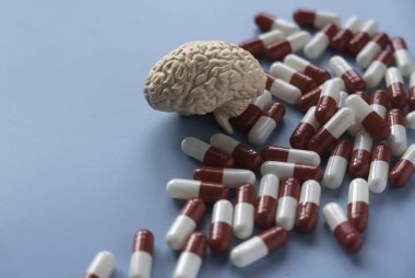 Concept of brain diseases, mental health, Alzheimer's, Parkinson's disease, dementia, stroke, and seizure. Nootropics use to improve memory and neural function. Brain model with a pills.