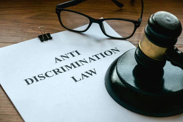 Anti discrimination law. Equality and human rights concept.Court scene judgement attorney. Document and gavel on wooden table.
