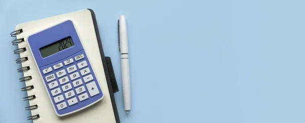 Concept of new year finance, inflation, recession, tax, budget and cost of living. Financial reminder of fiscal year 2024. 2024 on calculator screen.	