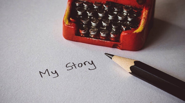 Writing a Story .Close-up of a Pencil, Paper, and Red Typewriter