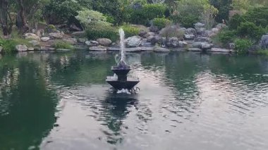 Yeşilliklerle çevrili Bereketli Bahçe Havuzu 'ndaki Huzur Çeşmesi