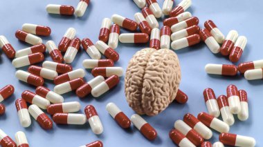 Mavi Arkaplanda Beyin Modeli ve Kırmızı ve Beyaz Kapsüller