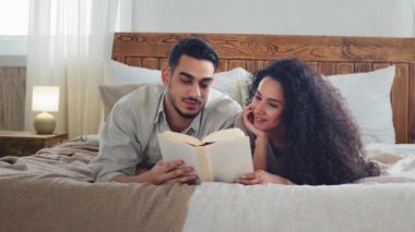 Çok ırklı evli çift, sakallı koca, karı koca, erkek arkadaş, erkek arkadaş, kız arkadaş, öğrenciler yataklarında uzanıp ilginç kitap kitapları, edebiyat kitapları ve ders kitapları okuyor.