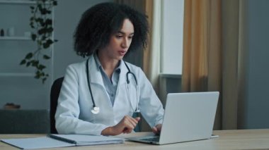 Uzman doktor Afrikalı kadın terapist hastayı internetten tedavi ediyor bilgisayarla sohbet ediyor uzaktan konuşma, hastanedeki internet bağlantısı, salgın izolasyonu sırasında tıbbi servis sağlıyor.