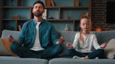 Barışçıl Kafkas ailesi genç babası ve kızı küçük kızı Lotus 'ta oturuyor birlikte meditasyon yapıyor sağlık egzersizleri yapıyor sakin olun stres dengesi yok