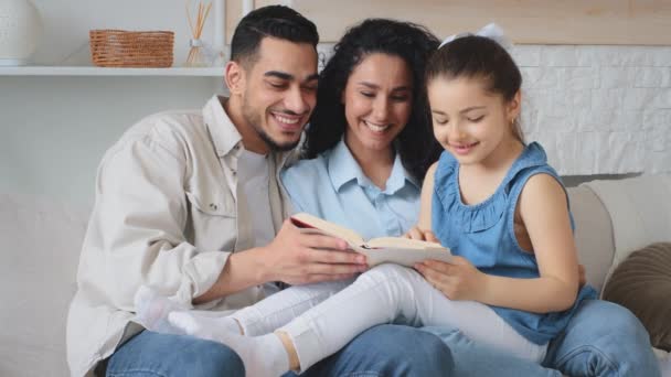 Hispanic Family Sitting Couch Home Weekend Reading Book Together Young — Stock Video