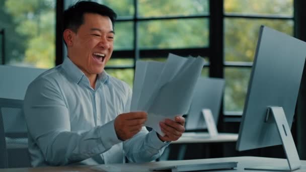 感情的に幸せなアジア人男性ビジネスマン事務員専門労働者中国人韓国人男性が書類作成を行う成功したビジネス取引スローオフィスの場所で紙を投げるが収益性の高い契約書を取得します — ストック動画