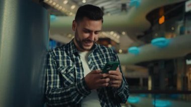 İşadamı ispanyol kullanıcı kullanıcısı cep telefonu ile akıllı telefon işi yapıyor çevrimiçi haberci internet sitesinde sohbet ediyor gülümseyen genç erkek iletişim sanal sohbet ağı uygulaması kullanıyor