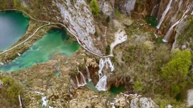 Aerial view top shooting from above beautiful waterfalls mountains nature of Croatian National Park Plitvice Lakes in Croatia. Panoramic drone shot gorgeous tourist place in Europe falling water rocks