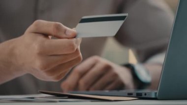 Close up hands of unrecognizable man and woman in bank table with laptop. Male agent insurance service manager give unknown girl credit card financial consultant man credits client with loan payout