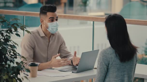 Man Hispanic Bank Worker Medical Face Mask Consulting Unrecognizable Client — Stok Video
