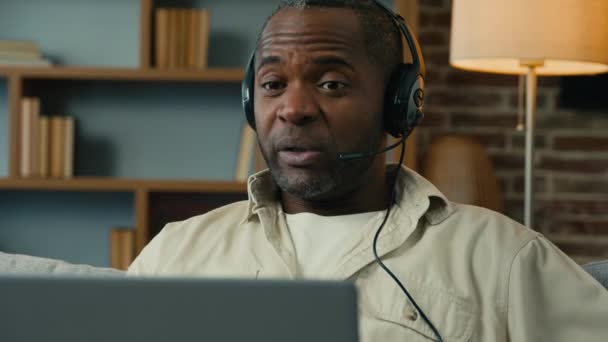 Mature Serious African Man Talking Video Call Using Headset Laptop — Vídeo de Stock