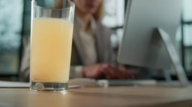 Close up glass of water with dizzy pill dose remedy tablet at office table painkiller drink prevent ache headache healthcare sparkling liquid cure at desk on background of Caucasian sick businesswoman