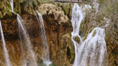 Plitvice lakes national park UNESCO lake in Croatia aerial view. Drone copter shooting Croatian waterfalls mountains river falling water cascade from rocks green landscape tourism to Europe waterfall