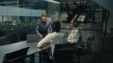 Indian Arabian leader company CEO boss leader male business coach man with laptop talk to multiracial colleagues diverse man and woman corporate studying project online service presentation in office