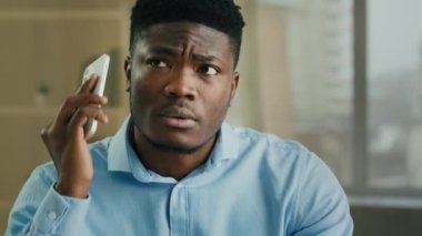 Businessman happy african american male executive manager office worker answer incoming mobile call speak telephone receive good news win job offer shocked man communicate by phone celebrate victory