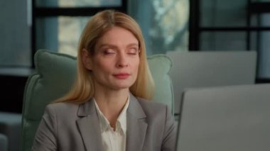 Caucasian middle-aged adult woman business 30s businesswoman entrepreneur worker employer in company corporate office with computer looking away smiling to camera. Female freelancer secretary portrait