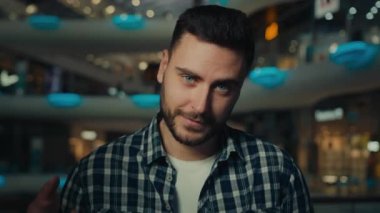 Male customer hispanic caucasian man businessman happy shopper buy gifts on holiday hold bags with presents fashion clothes from shop store luxurious boutique posing with packages Black Friday sales