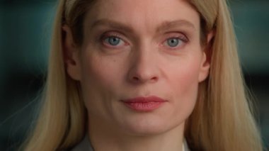 Serious Caucasian adult middle-aged businesswoman executive posing for business portrait in office. Female face close up smiling toothy. 40s woman in formal outfit looking to camera lady manager smile