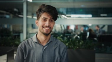 Portrait indian arabian ethnic multiracial 30s man boss leader businessman standing in office successful proud male ceo agent entrepreneur professional manager employee teacher smiling posing indoors
