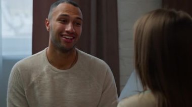 African american adult man talking with woman converse at home diverse ethnicity friends married spouses boyfriend girlfriend discussing future plans support loving couple sit indoors on romantic date