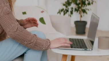 Close-up of female hands holding belly by side unrecognizable girl woman with laptop working feels bad digestive problems abdominal pain painful menstrual period illness suffers from liver damage ache