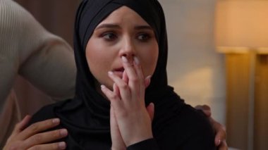 African american man care about sad offended crying arabian muslim woman diverse multiracial couple sit indoors loving husband calming wife cuddling apologize support empathy family relation problem