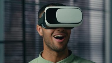Close-up amazed african american man with VR glasses playing video game in digital metaverse world male gamer businessman surprised by new innovative 3D technology using AR virtual reality goggles