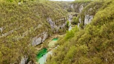 Landscape panoramic aerial top view flying drone shooting trees forest mountains waterfalls landmark of Plitvice lakes national park in Croatia. Nature of Croatian ecosystem. Tourism travel to Europe