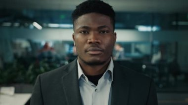 Serious unhappy man african american ethnic adult male looking at camera business portrait 30s businessman employee manager calm office worker stand indoors middle-aged crisis sad facial expression
