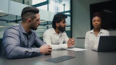 African American female businesswoman company CEO corporate mentor coach with laptop computer discuss startup service project software with multiethnic business team diverse men brainstorm in office