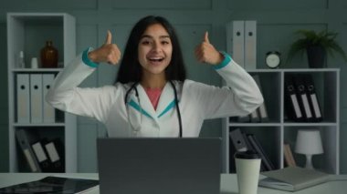 Happy doctor young practitioner nurse woman female pediatrician make thumb up hand gesture recommend health insurance good healthcare service promote immunization vaccination approved medicine quality