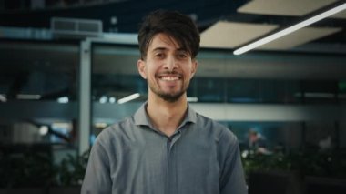 Portrait happy indian ethnic man professional businessman entrepreneur agent manager stand in office company smiling male looking at camera arabian adult 25s business owner millennial posing indoors