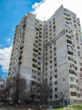 Kharkiv, Kharkov, Ukraine - 05.07.2022: bottom view damaged wall of civilian house destroyed building broken windows glass debris outside result of rocket strike shelling attack Russian war in Ukraine