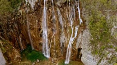 Plitvice lakes national park UNESCO world heritage Croatian lake with waterfall aerial view. Flying drone shooting landscape mountain falling water from rock forest waterfalls travel touristic place