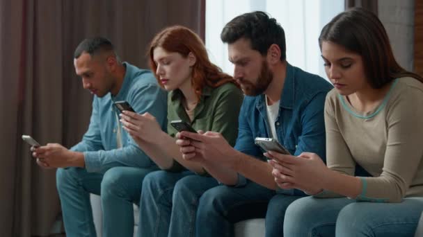 Millennial 30S Diverse People Sit Line Sofa Holding Smartphone Ignoring — ストック動画