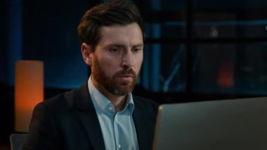 Sad caucasian businessman adult employee work with computer in evening office receive bad email wrong result upset disappointed man has business problem error incorrect data mistake bankruptcy crash