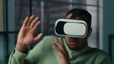 Scared worried african american man wearing virtual reality glasses playing scary 3d game in digital metaverse world indoors feel fear horror afraid ethnic male gamer use VR goggles play in cyberspace