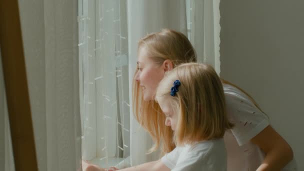 Caucasian Mother Little Preschool Daughter Standing Curtains Looking Window Talking — Vídeo de stock