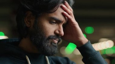 Arabian unhappy man unhealthy Indian guy worried with problem at parking lot headache depressed bearded male suffer from migraine complicated decision difficult divorce job loss business bankruptcy