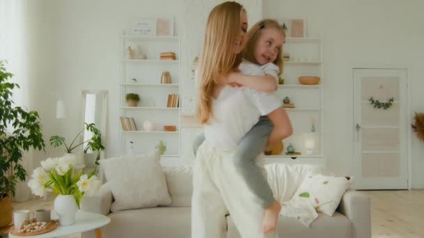 Caucasian Mother Babysitter Woman Holding Little Cute Girl Daughter Piggyback — Stock Video