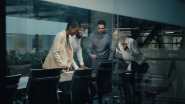 Multi-ethnic diverse business team coworkers colleagues corporate partners workers win with laptop celebrating good online result success stack hands put palms together united teamwork partnership